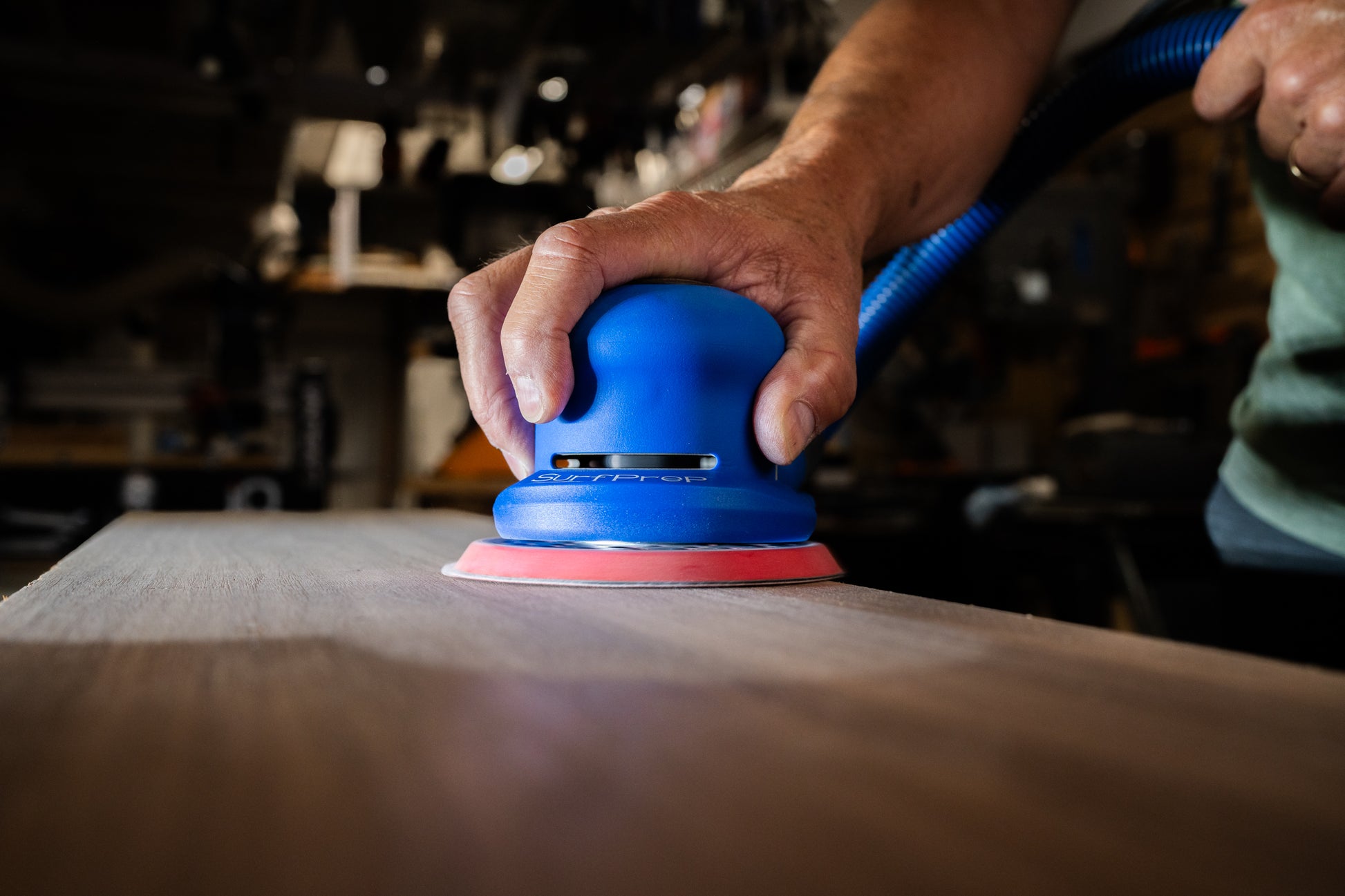 6" Gen 2+ SurfPrep electric Sander finishing wood with a white lightning disc.